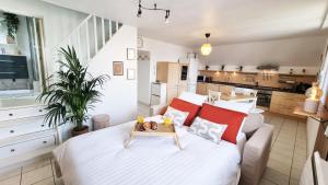 a bedroom with a large bed with a table on it at Duplex 4pers Calme Parking - Proche Gare & Rocade in Fleury-les-Aubrais