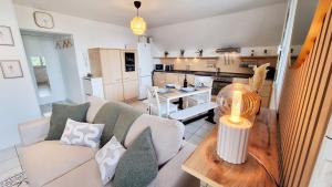 a living room with a couch and a table at Duplex 4pers Calme Parking - Proche Gare & Rocade in Fleury-les-Aubrais +29 photos