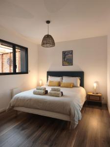 a bedroom with a bed with two pillows on it at Les Suites du Littoral in Plouézec