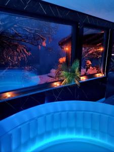 a window with a view of a swimming pool at night at Jajce,Plivsko jezero in Jajce