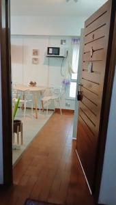a kitchen and dining room with a table and a door at Monoambiente Viamonte in Buenos Aires
