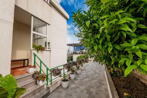 a walkway with potted plants on the side of a building at Dashamiri's Villa in Sarandë