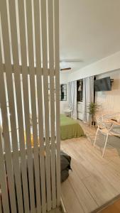 a bedroom with a bed and a table in a room at Monoambiente Viamonte in Buenos Aires +2 photos