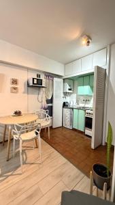 a small kitchen with a table and a dining room at Monoambiente Viamonte in Buenos Aires