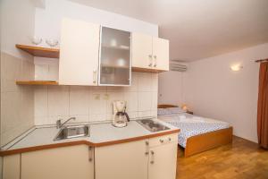 a kitchen with a sink and a bed in a room at Villa Albatros in Vinišće +171 photos