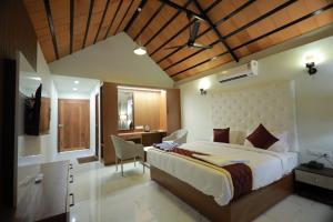 a bedroom with a large bed and a desk at Dee Cottage kanyakumari in Kanyakumari