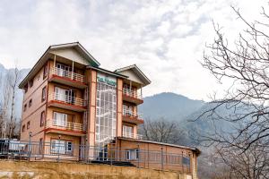 a tall building with balconies on top of it at Hotel Peak Paradise Resorts in Pahalgām +18 photos