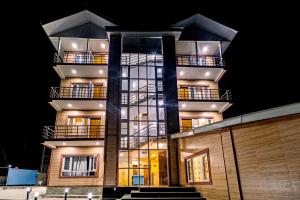 a tall building with balconies on the side of it at Hotel Peak Paradise Resorts in Pahalgām