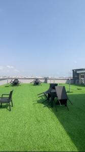 a group of picnic tables and benches on the grass at Dephantom Continental Hotel in Lagos