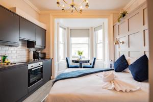 a bedroom with a large bed in a kitchen at Marina View Studio - Harbour in Dublin