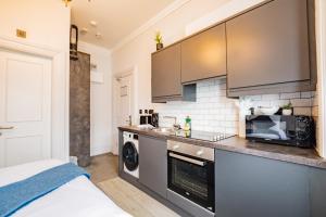 a kitchen with a washer and dryer in a room at Marina View Studio - Harbour in Dublin