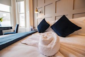 a bedroom with a bed with a towel on it at Marina View Studio - Harbour in Dublin +4 photos