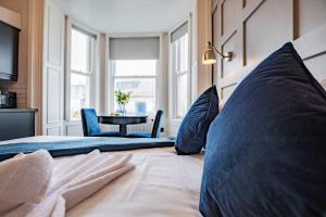 a bedroom with a bed with blue pillows and a table at Marina View Studio - Harbour in Dublin
