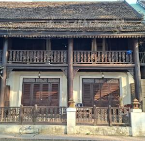 a balcony on the side of a house at Colonial House Mekong River View in Luang Prabang