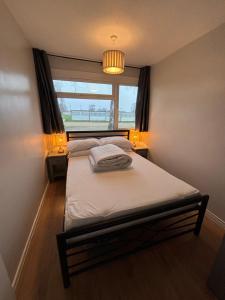a small bedroom with a bed with a window at 194, Two bed Chalet on Belle Aire Holiday Park - sleeps 4, pet friendly, free Wi-Fi, bed linen and towels included plus onsite entertainment available in Hemsby