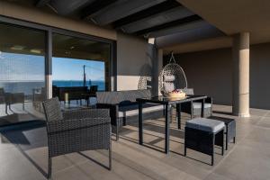 a dining room with a table and chairs at Sun and Sea Apartment - Beachfront, 2 Bedrooms with Sea View & Garden in Paralio Astros