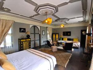 a bedroom with a bed and a living room at Dar HISANE in Marrakesh +103 photos