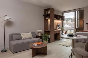 a living room with a couch and a table at The Pepper Mill - Campus Residence in Edinburgh