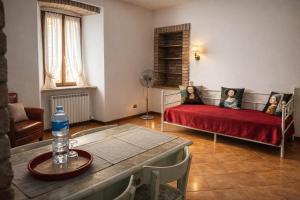 two women sitting on a bed in a living room at Residenza Il Castello Tre in CastellʼArquato