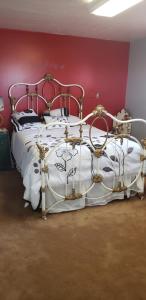 a bedroom with a white bed with a red wall at Beautiful Country Location in Harrisville