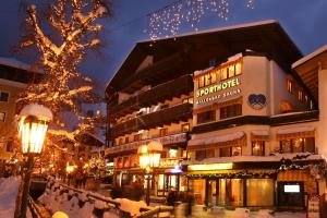 a large building with christmas lights in a city at Berger's Sporthotel in Saalbach-Hinterglemm