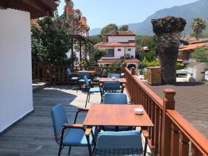 a patio with tables and chairs on a deck at Sarıyer Otel in Ula