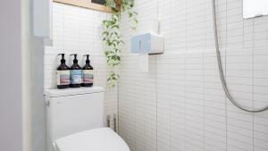 a bathroom with a toilet with bottles of wine at STR Stay Bangbae in Seoul +59 photos