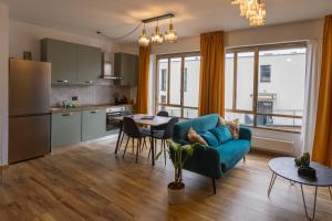 a kitchen and living room with a couch and a table at Lakeside Lugano in Lugano