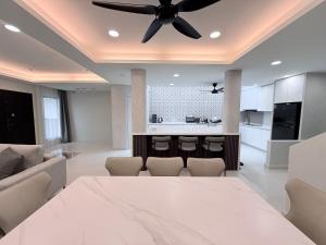 a kitchen and living room with a ceiling fan at Marble Manor - Elegant Landed house in Subang Jaya