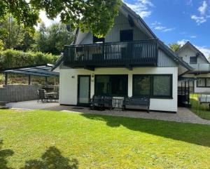 a large house with a deck and a patio at All inclusive Ferienhaus JULYN , Seepark in Kirchheim