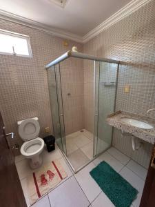 a bathroom with a shower and a toilet and a sink at Casa Freire in Maceió