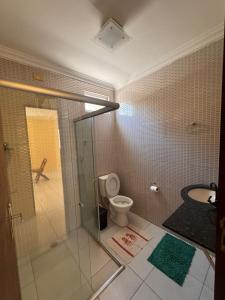 a bathroom with a shower and a toilet and a sink at Casa Freire in Maceió