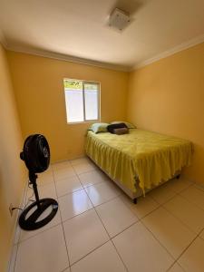 a bedroom with a bed in a room with yellow walls at Casa Freire in Maceió