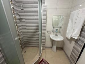 a small bathroom with a sink and a shower at Cactus Village in Blantyre +30 photos