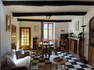 a living room with a couch and a table at Chez Julie in Valleraugue