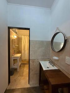 a bathroom with a sink and a mirror at Casa 2 hab, cerca del centro y costanera in Gualeguaychú +38 photos