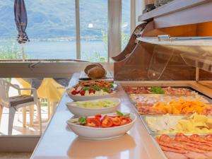 a buffet with many different types of food on a table at Hotel Garden Limone in Limone sul Garda +28 photos