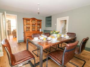a dining room with a wooden table and chairs at Old Post Office in York +15 photos