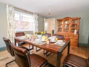 a dining room with a wooden table and chairs at Old Post Office in York