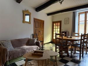 a living room with a couch and a table at Chez Julie in Valleraugue