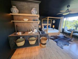 a bathroom with a sink and a bed in a room at Forest Nature Spa in Plettenberg Bay