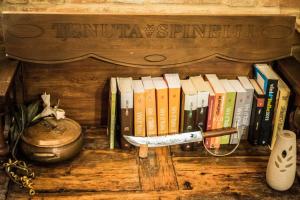a book shelf with a bunch of books and a knife at Agriturismo San Filippo Neri in Castignano