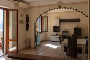 a kitchen and living room with a table and a dining room at Tra Tetti e Mare - HelloElba in Portoferraio