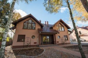 a house in the woods with trees at Apartamenty Biskupice in Biskupice