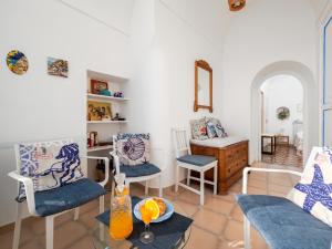 a living room with two chairs and a table at A la casa del cavaliere in Positano