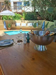 a bowl on a table next to a swimming pool at Forest Nature Spa in Plettenberg Bay