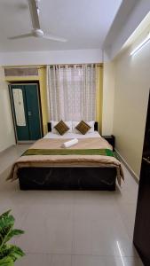 a bedroom with a large bed in a room at Mayabini Homestay 3BHK in Guwahati +4 photos