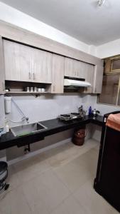 a kitchen with a sink and a counter top at Mayabini Homestay 3BHK in Guwahati