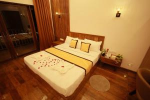a bedroom with a bed with flowers on it at Crystal Falls Wayanad in Wayanad