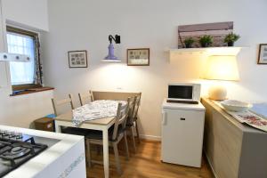 a kitchen and dining room with a table and a stove at Alla Cantina in Aurisina Case